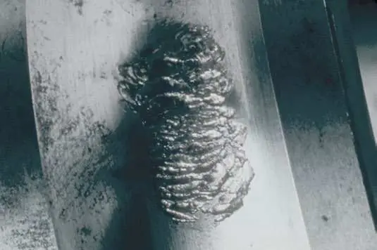 Photo of a failed rolling bearing with visible raceway damage, the kind of image Bearing Autopsy reads