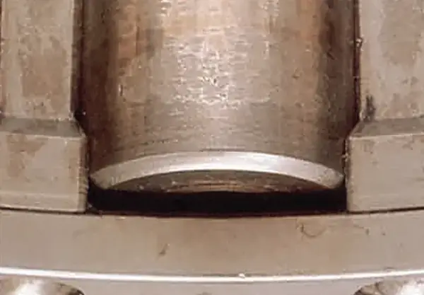 Smearing and wear on a roller from lubricant contaminated with water or other matter.