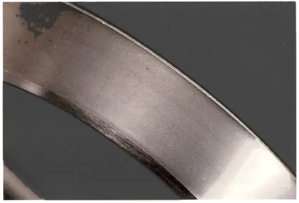 Satin finish on a raceway from fine abrasives in the oil.