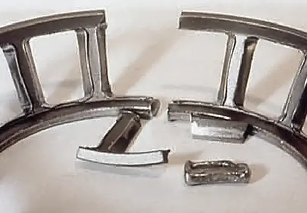 Broken cage from impact or excessive vibration.
