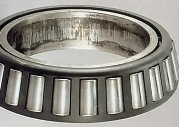 Fretting corrosion on the inner ring bore: interference too light for the load.