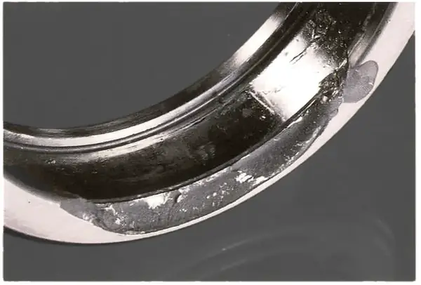 Brittle fracture of an outer race rib, a sign of a severe shock load.
