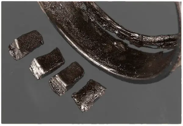 Later stage: discoloured, damp, cooked or carbonised oil when high temperature was reached.