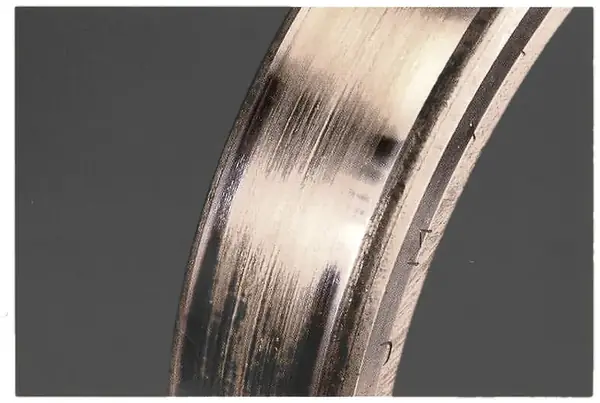 Creep: smooth, polished outside diameter and ring face where the ring turned in the housing.