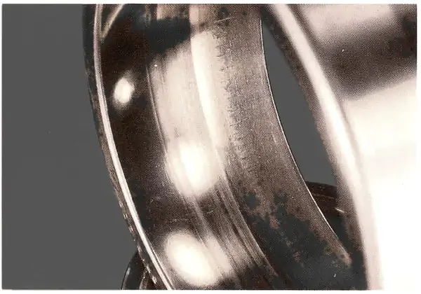 Early stage on a different bearing: roughening and fine axial cracking of the raceway.