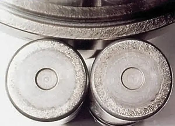 Scuffing on roller end surface and inner ring rib.
